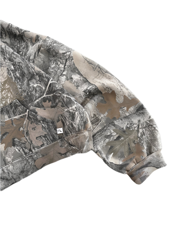 A close-up of the sleeve of a minimalist akimbo style camo hoodie, featuring subtle detailing and clean lines, set against a stark white background. The design reflects the understated aesthetic of obscure collective and streetwear culture, blending simplicity with modern urban style.