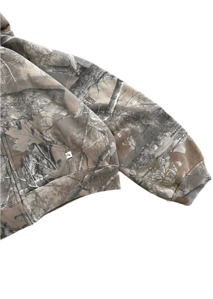 A close-up of the sleeve of a minimalist akimbo style camo jacket, featuring subtle detailing and clean lines, set against a stark white background. The design reflects the understated aesthetic of obscure collective and streetwear culture, blending simplicity with modern urban style.