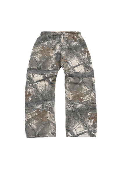 Front-facing image of Akimbo Style Camo Sweatpants from Obscure Collective, featuring a distressed camouflage design, loose fit, and streetwear style, set against a white background.