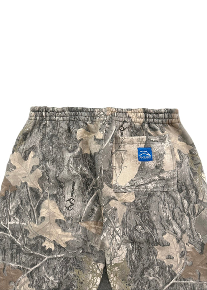 Rear-facing closeup image of the waist of Akimbo Style Camo Sweatpants from Obscure Collective, featuring a distressed camouflage design, loose fit, and streetwear style, set against a white background.