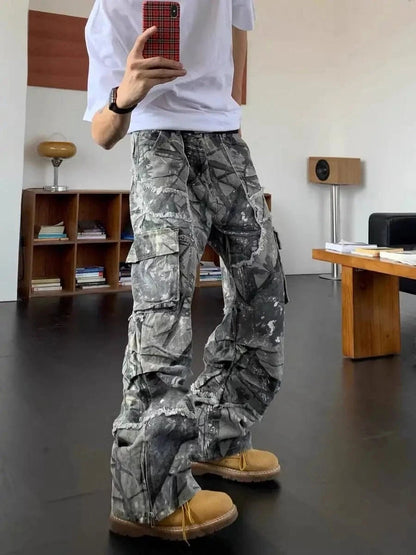 Mirror selfie of a model wearing Obscure Collective's Camo Pants, highlighting the bold camouflage design, relaxed fit, and streetwear-inspired aesthetic.