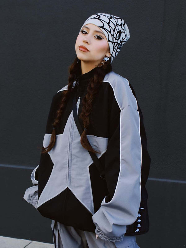 Model wearing Obscure Collective's Star Bomber Jacket in grey, standing confidently, highlighting the bold star embroidery and sleek streetwear design, set against a black background.